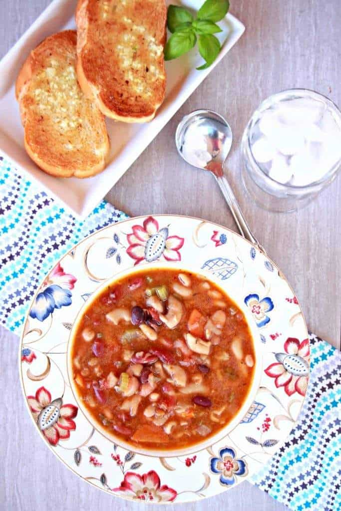 Vegetarian15 Bean Soup in the Instant Pot Vegetarian15 Bean Soup in white floral bowl with bread on the side