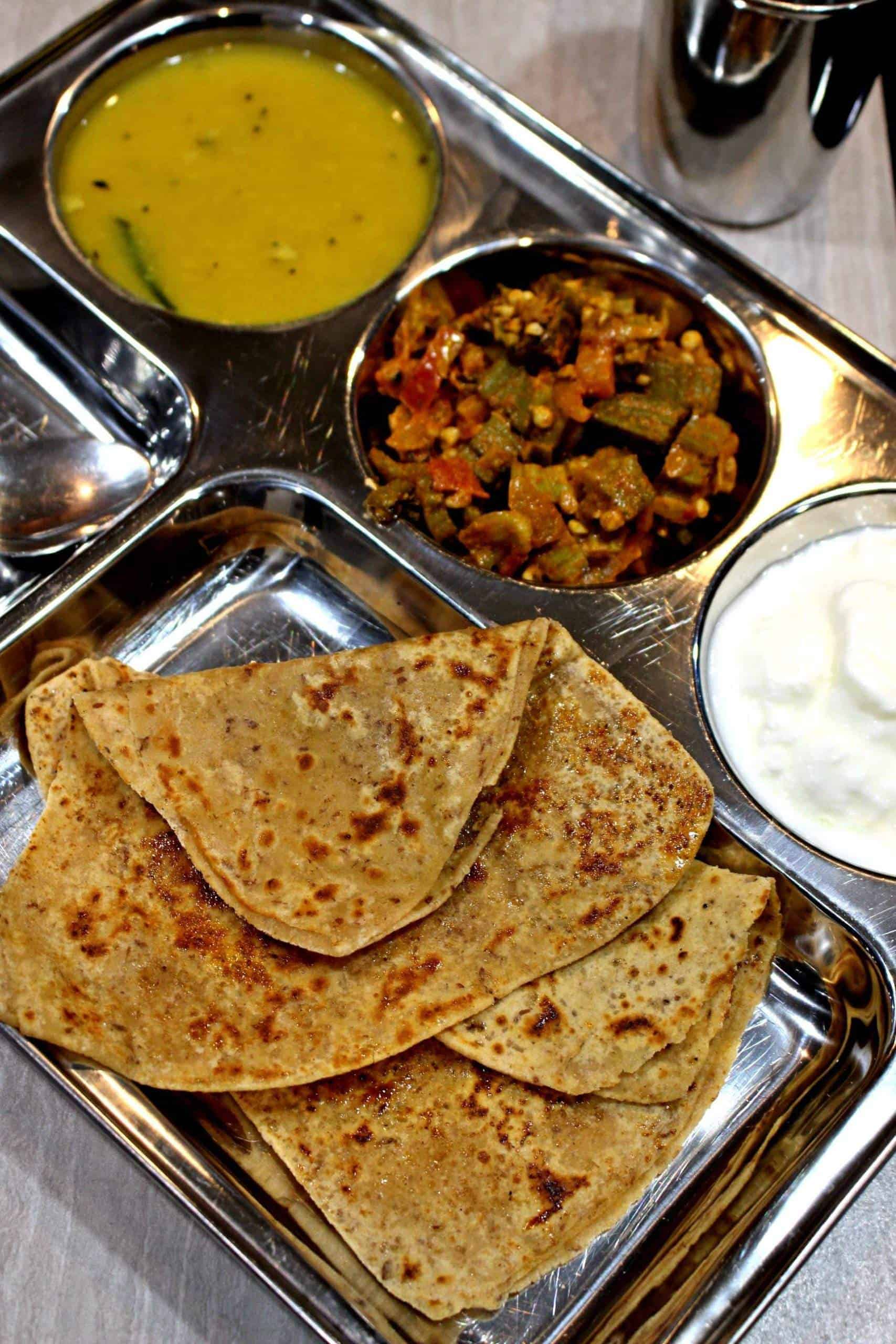 Sweet Paratha | Sweet Roti | Sugar Stuffed Flatbread Sweet Paratha on a stainless steel plate
